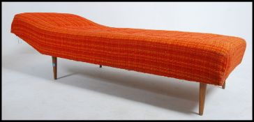 A retro / vintage mid 20th century day bed / chaise. The bed being raised on tapered stub legs and