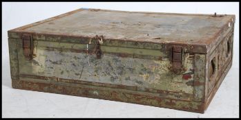 A vintage 20th century tin steamer trunk of square form, hinged lid and clasps to the front.