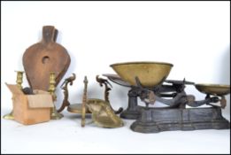Two sets pf vintage cast metal balance scales together with a pair of brass candle sticks etc.