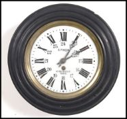 A French ebonised early 20th century bulls eye wooden cased pendulum station clock with a hinged and
