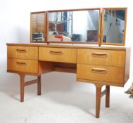 A 1970's Danish inspired retro teak wood dressing table. The desk with central kneehole recess