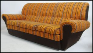 An original 1970's retro 3 piece suite - sofa and 2 armchairs. The suite in the original vivid