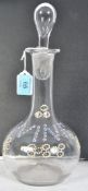 A 19th century enamel decorated blown glass decanter. The bulbous body with enamelled notation '