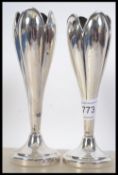 A pair of silver hallmarked bud vases having London assay marks, dating to 1934. 15cms high