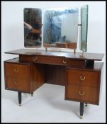 A retro 1960's G-Plan Librenza pattern dressing table raised on tapering supports having a series of