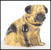 A ceramic 19th century Victorian Staffordshire figurine of a Pug dog.  Treacle glazed, of large form
