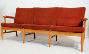 A 20th century contemporary Farstrup Danish 3seat sofa settee being raised on light wood turned