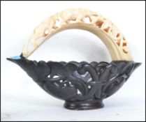 A carved wooden basket with carved bone handle. Me