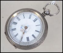 A continental ladies silver pocket watch. Having an enamel face with a  roman numeral chapter ring