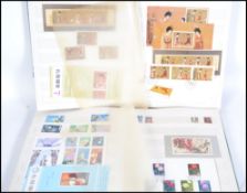 A collection of Chinese and Oriental stamps and presentation packs most appear unused held within