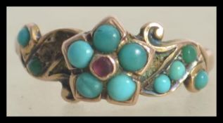 A believed Victorian 9ct / 375 hallmarked ladies turquoise and ruby ring. Set on a gypsy setting