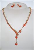 A decorative 20th century rhinestone and gilt metal ladies pendant necklace and earring set. The