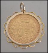An 1861 Shield back young bust Victorian gold sovereign being set within a 9ct gold necklace pendant