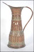 A 19th century handbeaten Turkish jug of tapering form having s-scroll handle with flared pourer