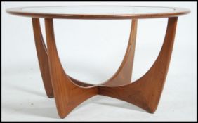 A vintage mid 20th century G Plan atomic teak wood round coffee table with drop in glass centre