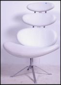 After Poul Volther. A `Corona` swivel lounge chair, with white vinyl upholstery to the pebble