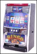 A 20th century ' Bingo ' fruit machine. Table top height sized machine complete with tokens etc