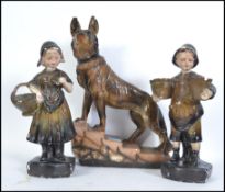 An early 20th century carnival  chalkware Alsatian dog figurine together with a carnival chalkware