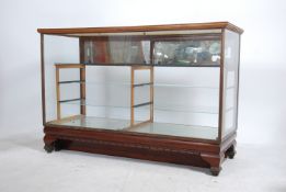 A vintage early 20th century oak haberdashery glazed shop display counter. Having a run of glass