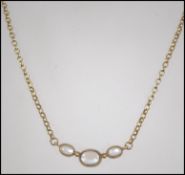 A ladies 9ct gold and moonstone necklace. Length 3