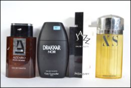 A collection of 4 large shop display perfume - aftershave bottles to include Jazz by Yves Saint