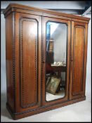 A Victorian Arts & Crafts mahogany inlaid triple w