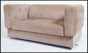 A retro 20th century Parker Knoll two seater drop end settee / sofa, upholstered in a patterned