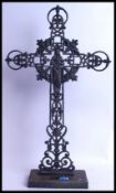 A large vintage style 20th century cast iron crucifix with Jesus to front, Mary to back placed in