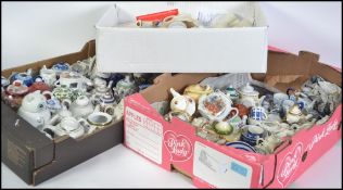 An extensive mixed lot of miniature teapots and crested ware.  This collection features some unusual