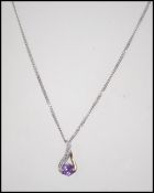 A 9ct white gold diamond and amethyst necklace and