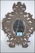 A 19th century gilt metal rococo wall mirror adorn