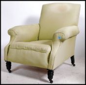 A Victorian mahogany Howard & Sons style armchair being raised on turned legs with ceramic castors