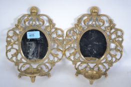 A pair of 20th century decorative cast brass wall