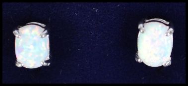 A pair of ladies silver and opal stud earrings, ea