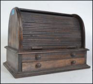 A 20th century Georgian revival oak tambour top roll down stationary desk tidy. Arched form with