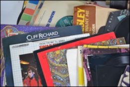 A collection of vinyl long play / LP records together with some 45rpm vinyl singles ating from the