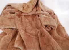 A vintage 20th century ladies knee length fur coat ( possibly rabbit ) in a light golden colour. (
