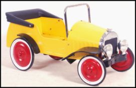 A retro late 20th century pedal car - brum made of
