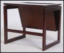 A retro 20th century dark teak and tile top magazine rack coffee table. Raised on squared legs
