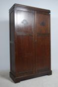 A 1930's oak double wardrobe compactum having oak full length qtr panel doors with haberdashery