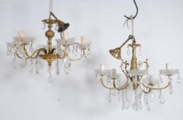 A pair of mid century vintage gilt metal rococo style 5 branch ceiling light chandeliers. Each