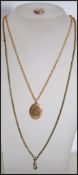 A 9ct gold small round locket with chase decoration. Together with a 9ct gold front and back oval