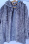 A vintage 20th century ladies hip length fur coat  in a soft grey colour.