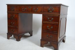 A mahogany Georgian style twin pedestal, gilt tooled green leather top over three frieze and six