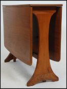 A retro 20th century G-Plan teak drop leaf dining table having splayed foot frame, the end leaves