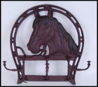 A large vintage style, 20th century cast iron brown horse head boot holder. Measures approximately
