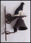 A vintage style, 20th century cast iron border collie bell. Measures 34cms tall.