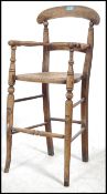 A Victorian 19th century Thonet style bentwood childs high chair having rattan weave seat with