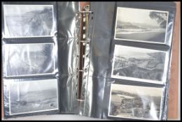 A good collection of vintage 20th century postcards in an album dating back to the Edwardian era
