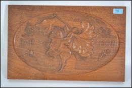 A 20th century wooden plaque carved in relief with